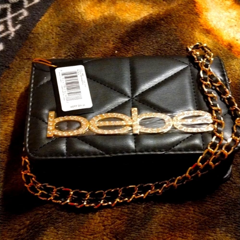 Elegant black BB designer purse with the elegant gold straps with black lining